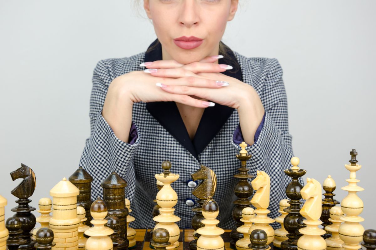 Woman in suit playing chess